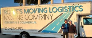 Two men in front of a Rowe's Moving truck
